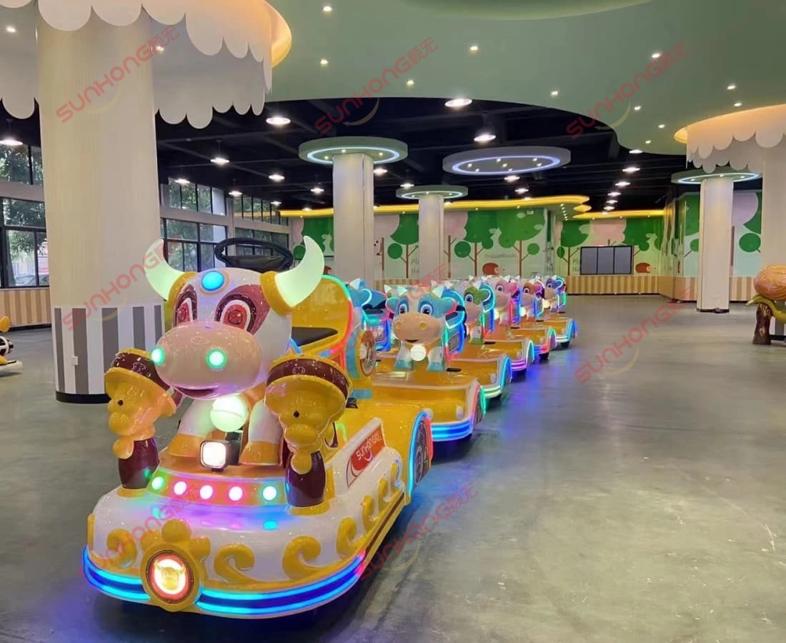 bull-train-indoor-display-small-trains-for-parks - SUNHONG Bull Train indoor display with full lighting effects, showcasing a lineup of small park trains - SUNHONG