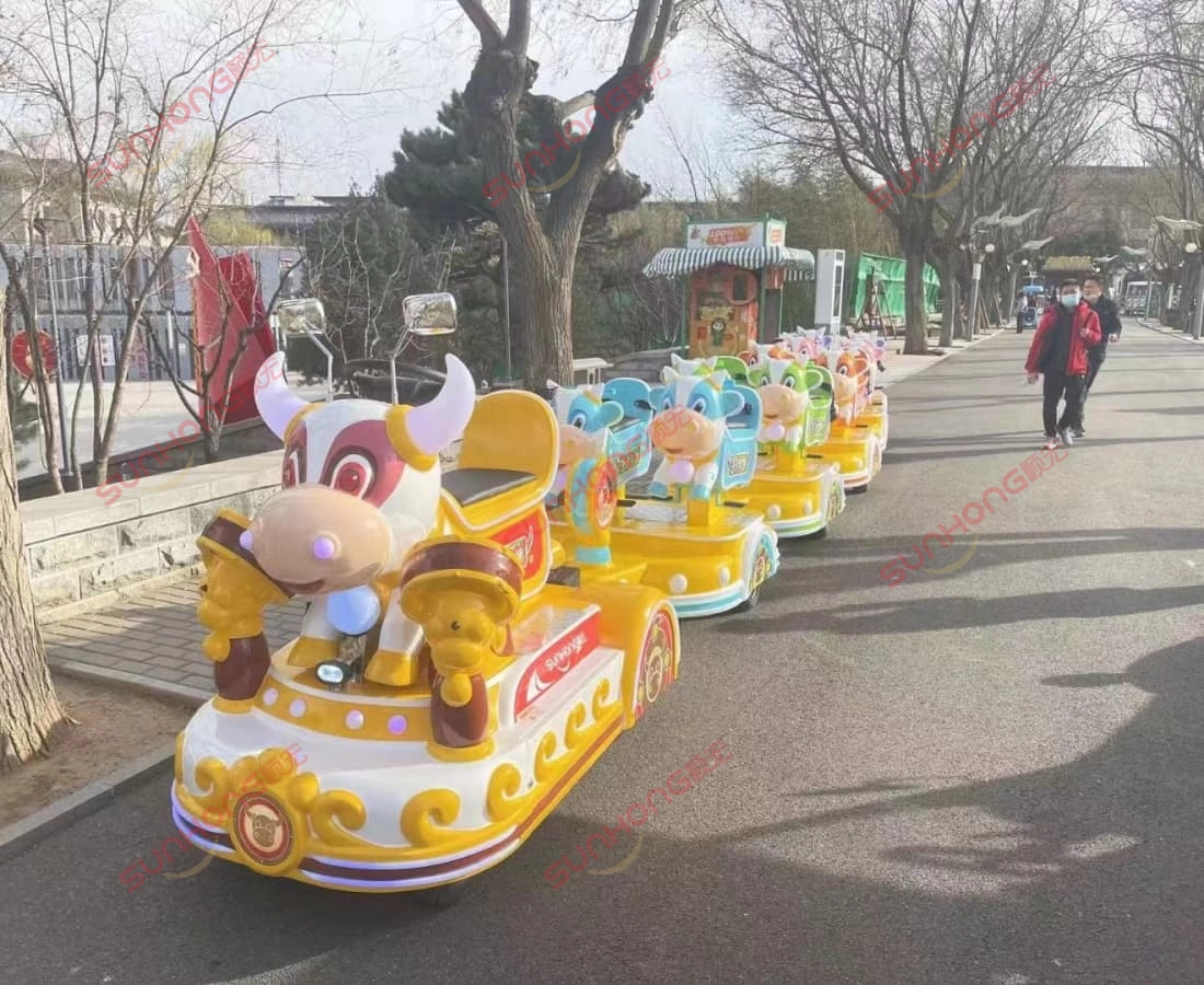 bull-train-outdoor-park-electric-ride - SUNHONG Colorful electric bull train driving through park walkway, small trains for parks - SUNHONG