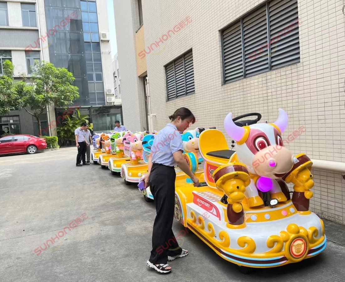 bull-train-outdoor-testing-small-trains-for-parks - SUNHONG Staff testing Bull Train, a cartoon-themed small train for parks, in outdoor setting - SUNHONG