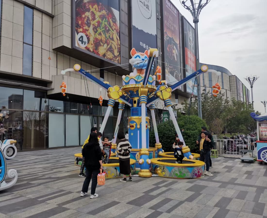 Mother and child enjoy Cat Fishing Trampoline at the shopping plaza, interactive trampoline bungee jump ride - SUNHONG