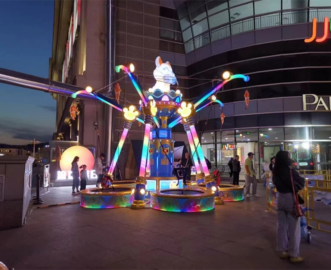 Cat Fishing Trampoline at night outside the shopping mall, vibrant bungee swing ride for kids - SUNHONG