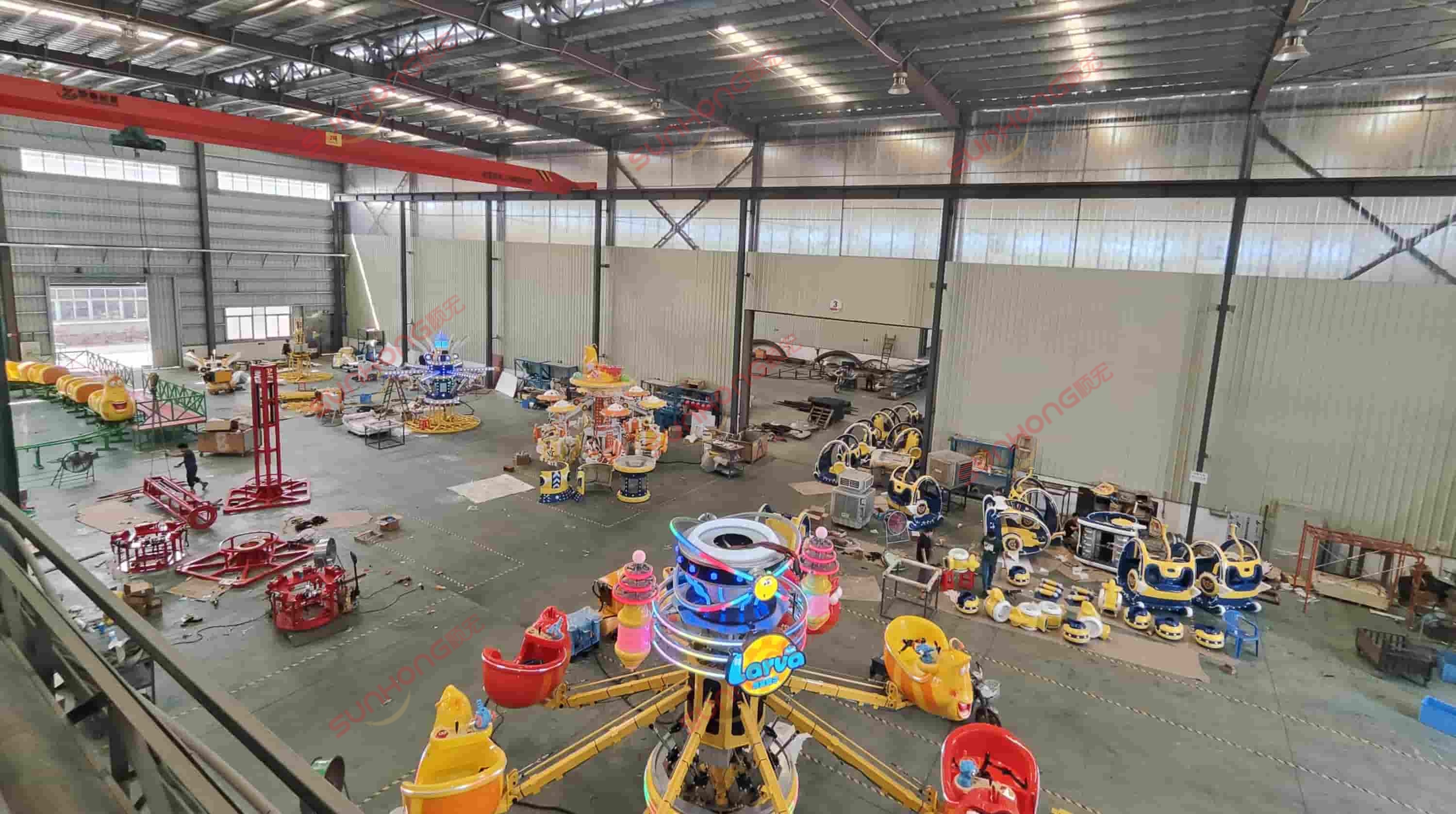 children-rides-production-line Assembly area filled with bright children’s rides at SUNHONG amusement ride factory, showcasing production capacity.