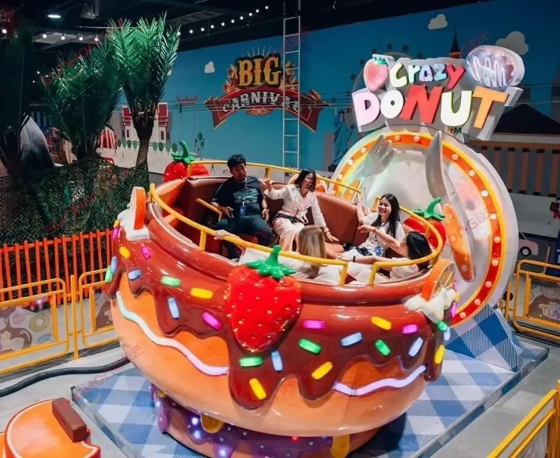 Crazy-Donut-Tagada-Roating-Amusement-Ride A colorful Crazy Donut Tagada rotating amusement ride with donut-shaped seats and vibrant lights, ideal for indoor amusement parks and family fun centers.