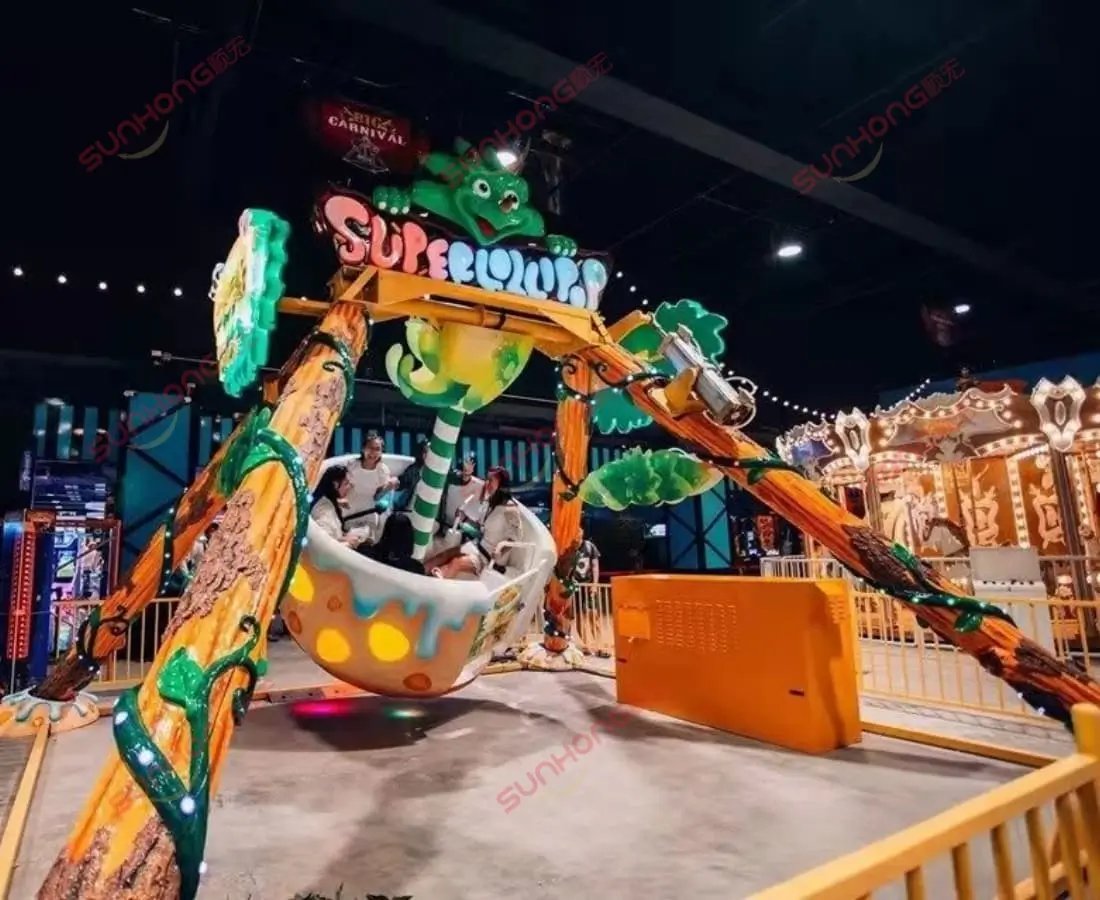 Dinosaur-themed pendulum amusement ride with IP-customized design, featuring vibrant tree trunks, cartoon dinosaur decorations, and swinging motion at an indoor theme park.