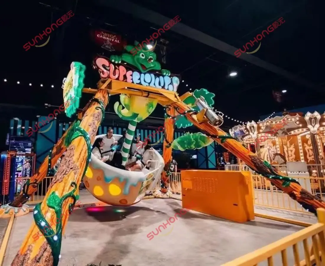 Dinoosaur-Pendulum-Amusement-Ride Dinosaur-themed pendulum amusement ride with IP-customized design, featuring vibrant tree trunks, cartoon dinosaur decorations, and swinging motion at an indoor theme park.