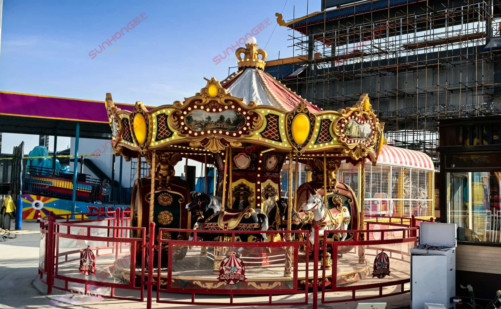 Ornate carousel with horses at a Marvelous Circus under a clear blue sky. Ornate carousel with horses at a Marvelous Circus under a clear blue sky.