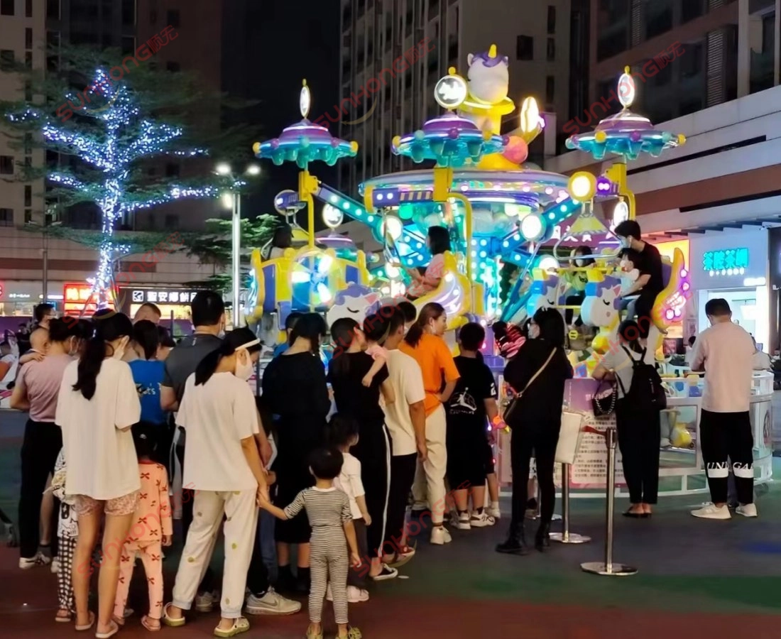fairy-unicorn-ride-night-queue-children - SUNHONG Families and children queuing at night to ride the Fairy Unicorn Amusement Ride, highlighting its popularity and family appeal. - SUNHONG