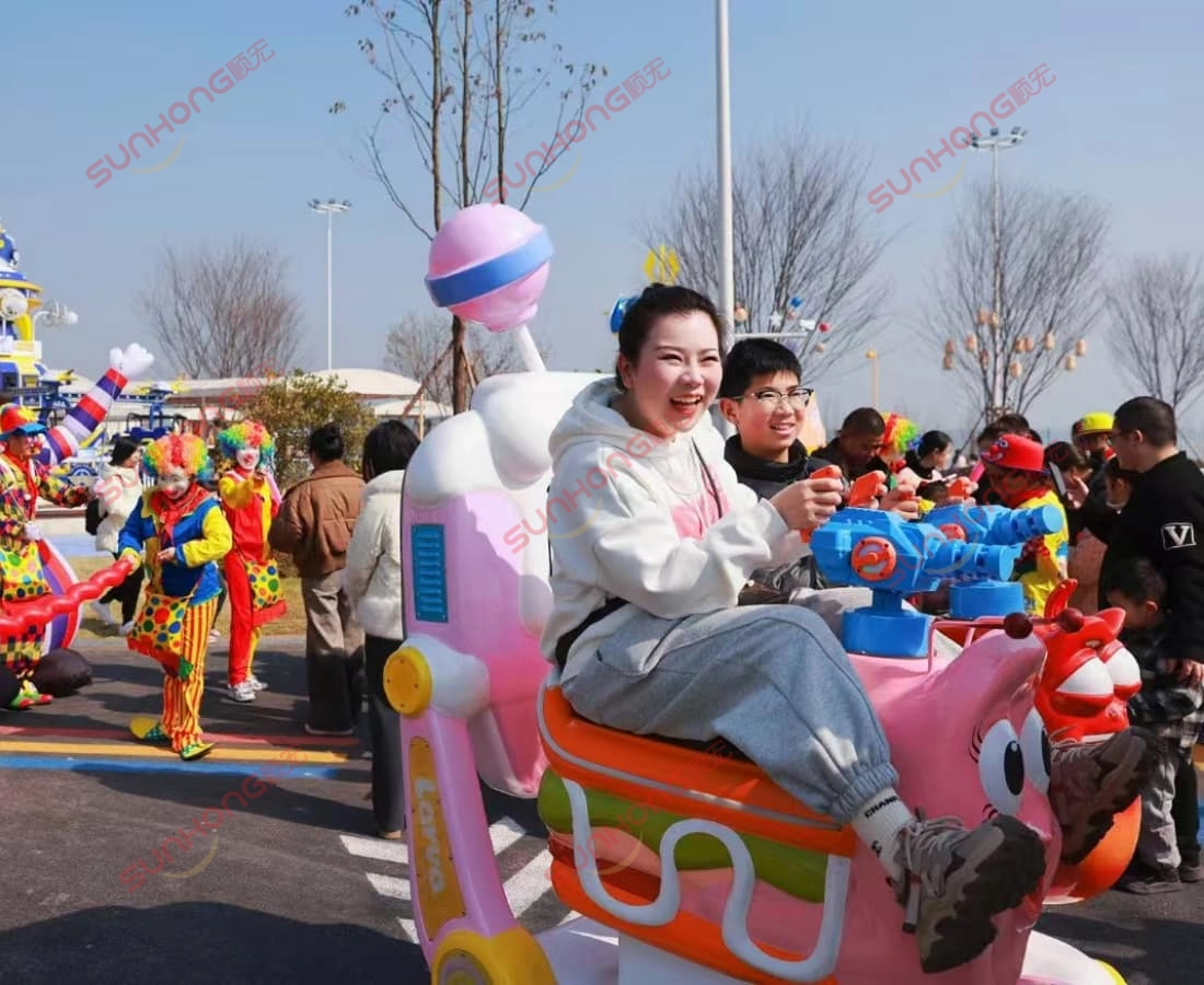 girl-laughing-on-larva-train-in-theme-park - SUNHONG Smiling girl enjoys a joyful ride on the Larva Ranger trackless train after entering the themed park — family-friendly train ride for sale. - SUNHONG