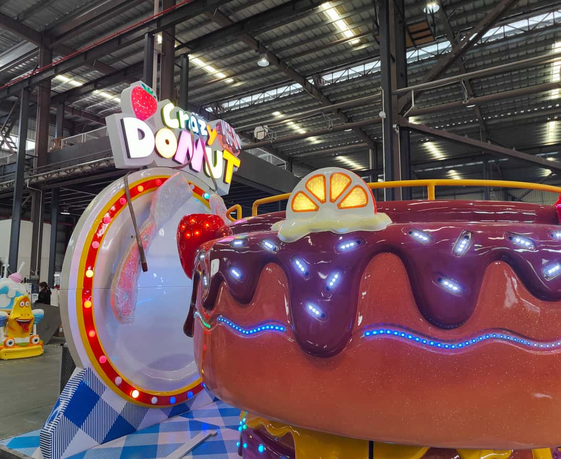 Side view of the Donut Tagada Ride at SUNHONG factory, showing its compact design for indoor amusement parks - SUNHONG