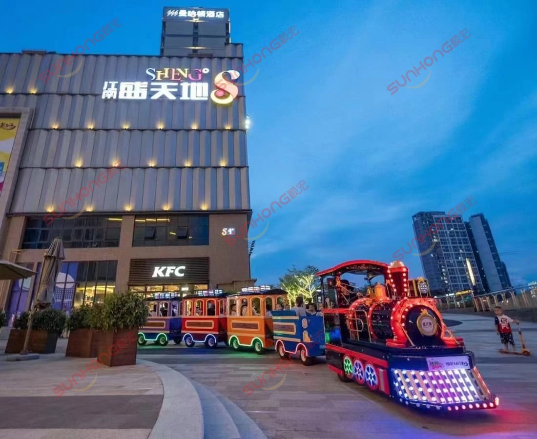 kingly-trackless-train-night-shopping-mall.jpg - SUNHONG 带LED灯的皇家无轨火车在购物中心附近夜间运行,用于活动的电动皇家无轨火车 - SUNHONG