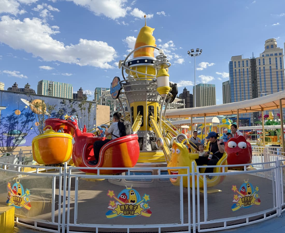 larva-air-combat-full-ride-with-kids Larva Air Combat ride filled with children in the themed amusement park, attracting many visitors