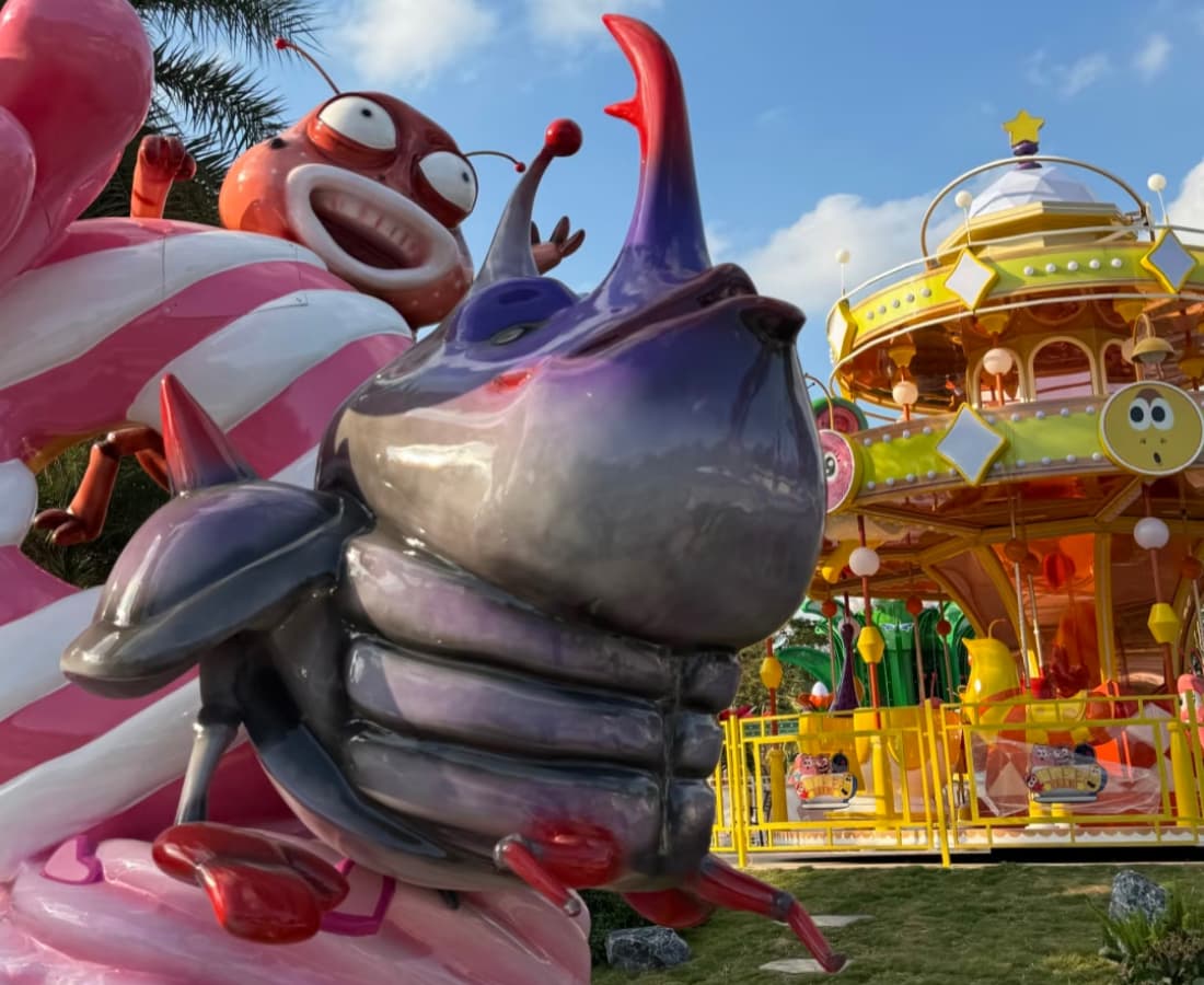 Larva theme park carousel with character sculptures and ride entrance details - SUNHONG