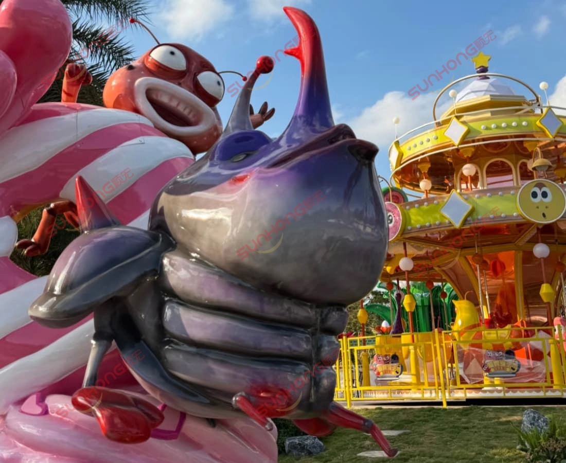 larva-carousel-character-decoration.jpg - SUNHONG Larva theme park carousel with character sculptures and ride entrance details - SUNHONG