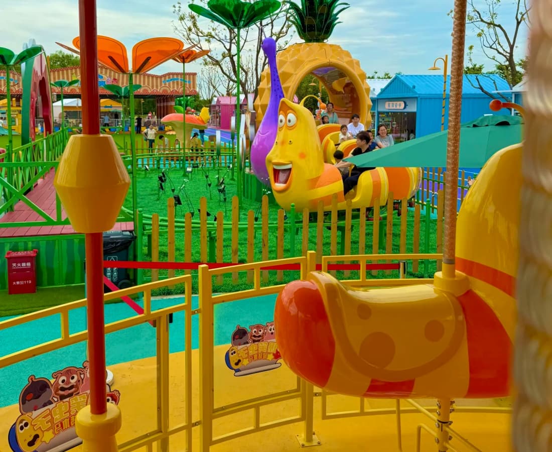 Kids riding Larva-themed carousel with animal-shaped seats in amusement park - SUNHONG