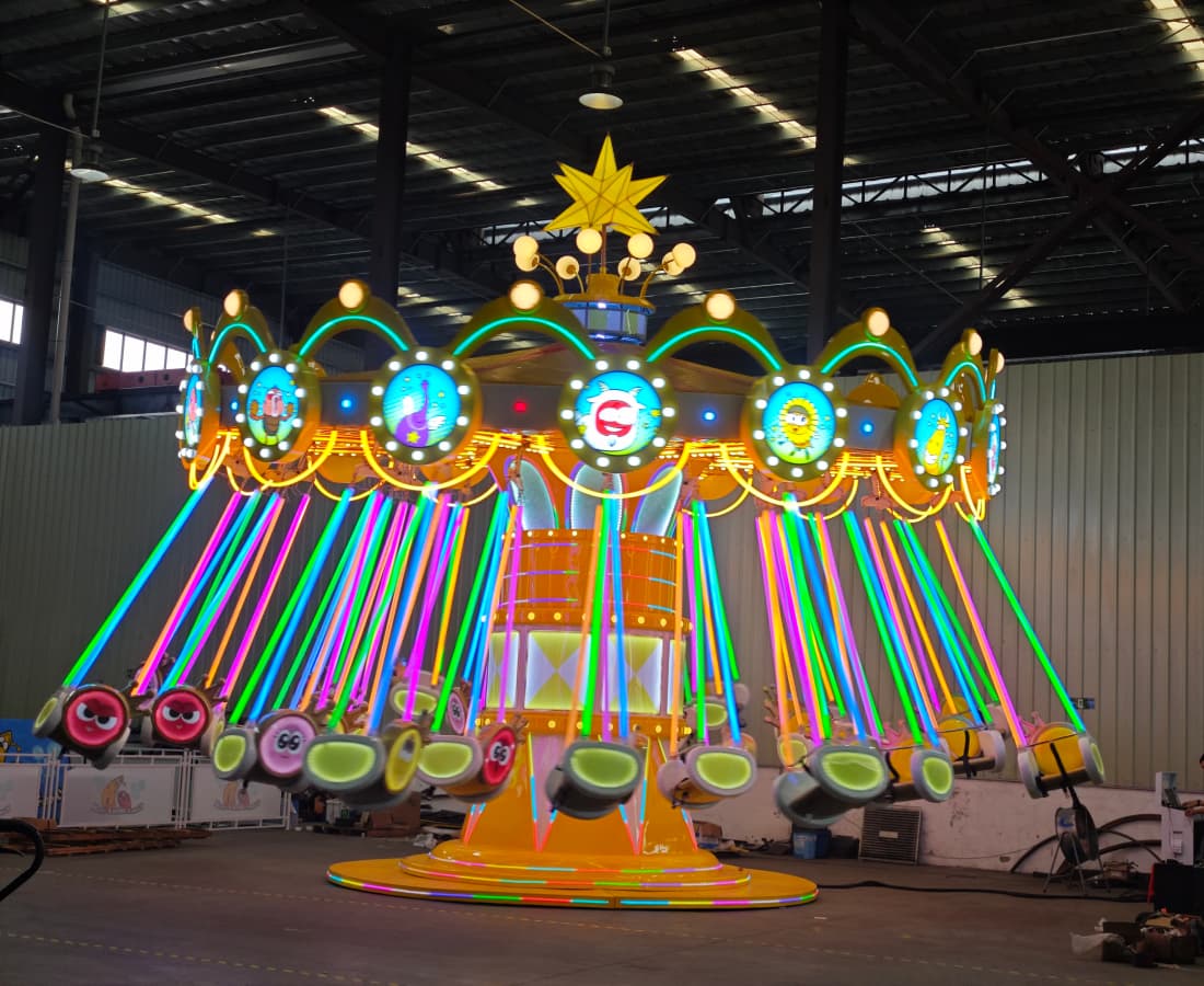 Larva-Flying-Chair-Swing-Ride-Testing-SUNHONG-Factory-Dazzling-Lights.jpg Larva Flying Chair swing ride being tested at SUNHONG factory, with dazzling lights as the chair swing rises.