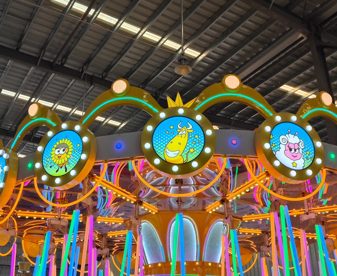 Close-up of the top structure of the Larva Flying Chair swing ride, showcasing its unique design. - SUNHONG