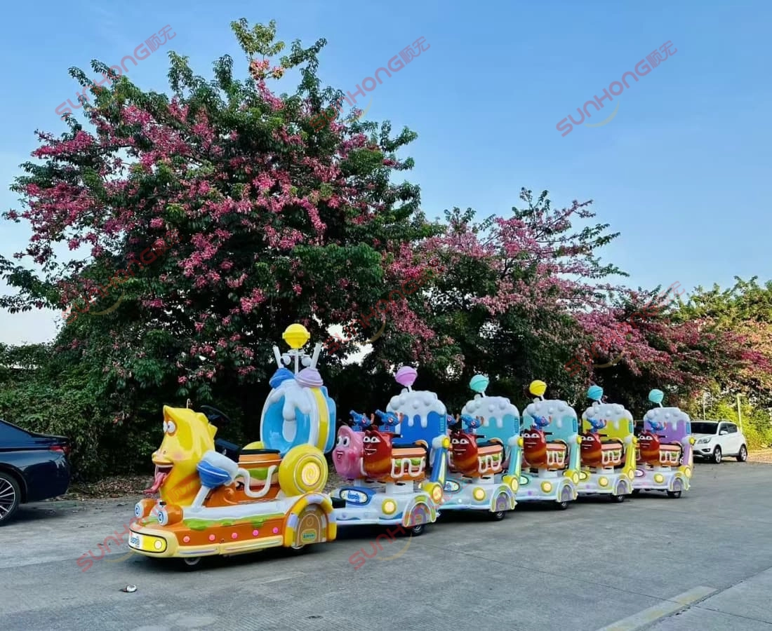 larva-ranger-train-riding-red-flowers-background - SUNHONG Larva Ranger trackless train ride for sale running along a path lined with blooming red flowers, showcasing its outdoor appeal. - SUNHONG
