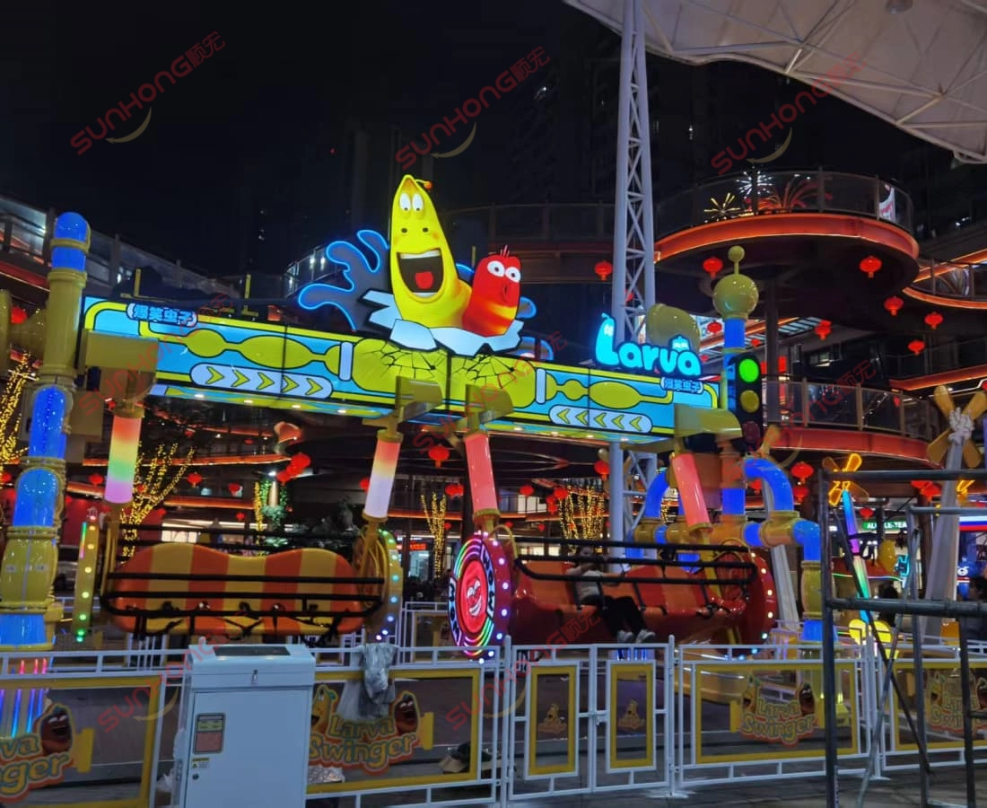 larva-swing-ride-for-sale-night-glowing - SUNHONG Larva Swing ride for sale glowing brightly at night in amusement park. - SUNHONG
