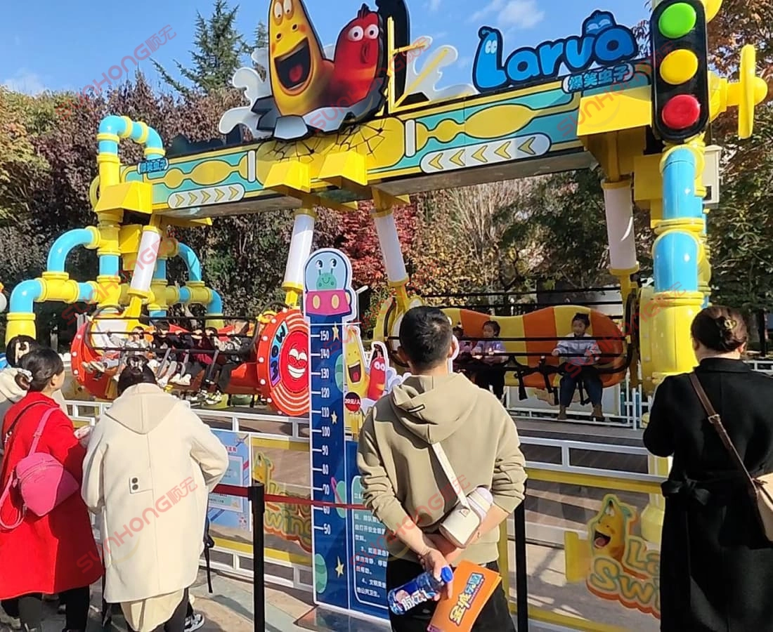 larva-swing-ride-for-sale-theme-park-side-view-crowd - SUNHONG Side view of Larva Swing ride for sale in theme park attracting visitor attention. - SUNHONG