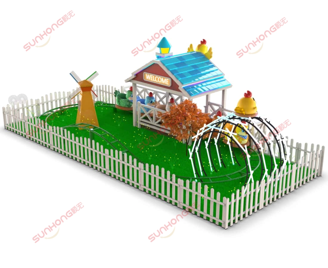 little-chicken-kiddie-coaster-overview - SUNHONG Little Chicken Team kiddie coaster ride with windmill and curved track in fenced green playground - SUNHONG