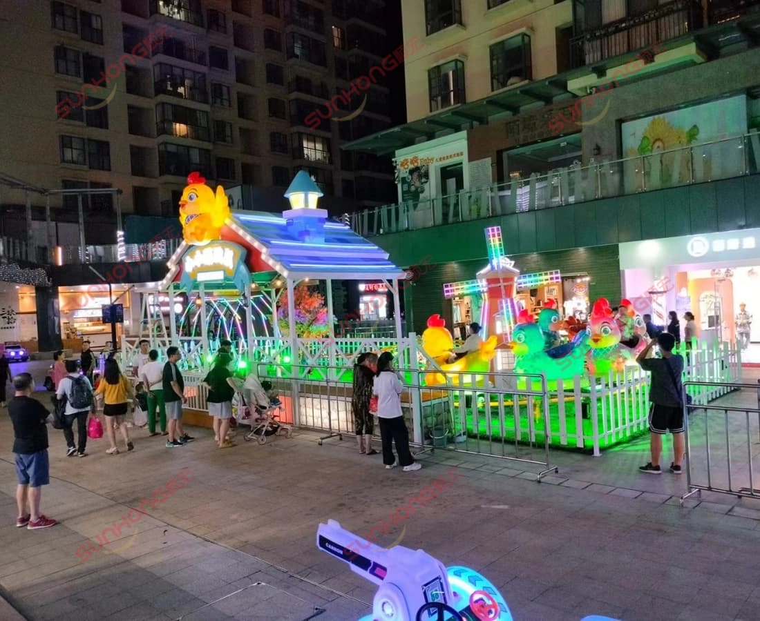 小鸡迷你杯垫五彩之夜 - SUNHONG 购物区夜间色彩缤纷的鸡主题儿童过山车展示 - SUNHONG