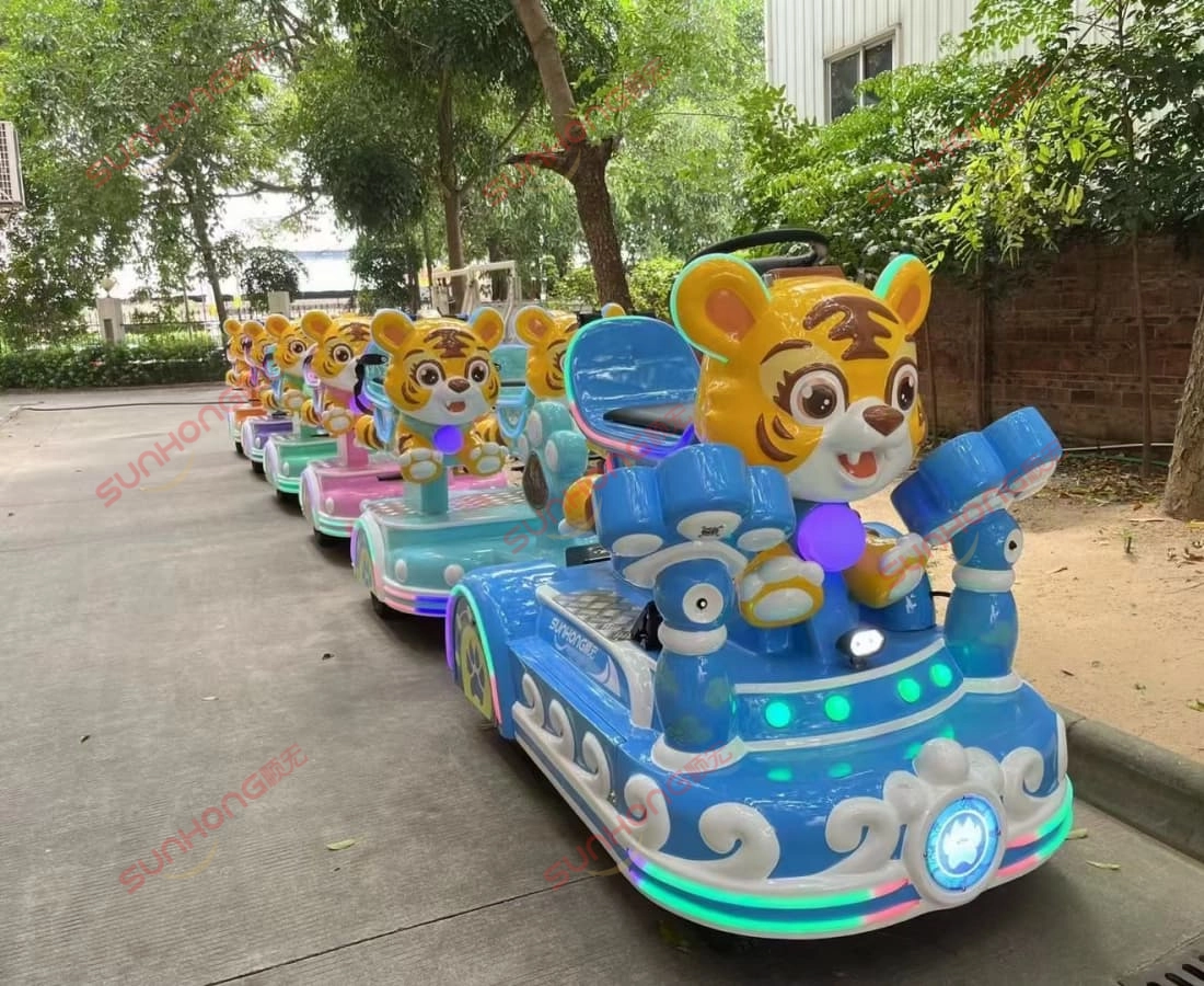 outdoor-tigger-trackless-train-park-path - SUNHONG Tigger trackless train ride cruising a shaded path in an outdoor park with colorful carriages. - SUNHONG
