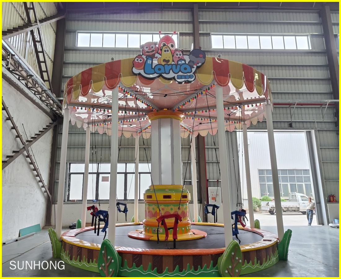 Front view photo of the Larva Bungee Party trampoline ride at SUNHONG’s production workshop. - SUNHONG