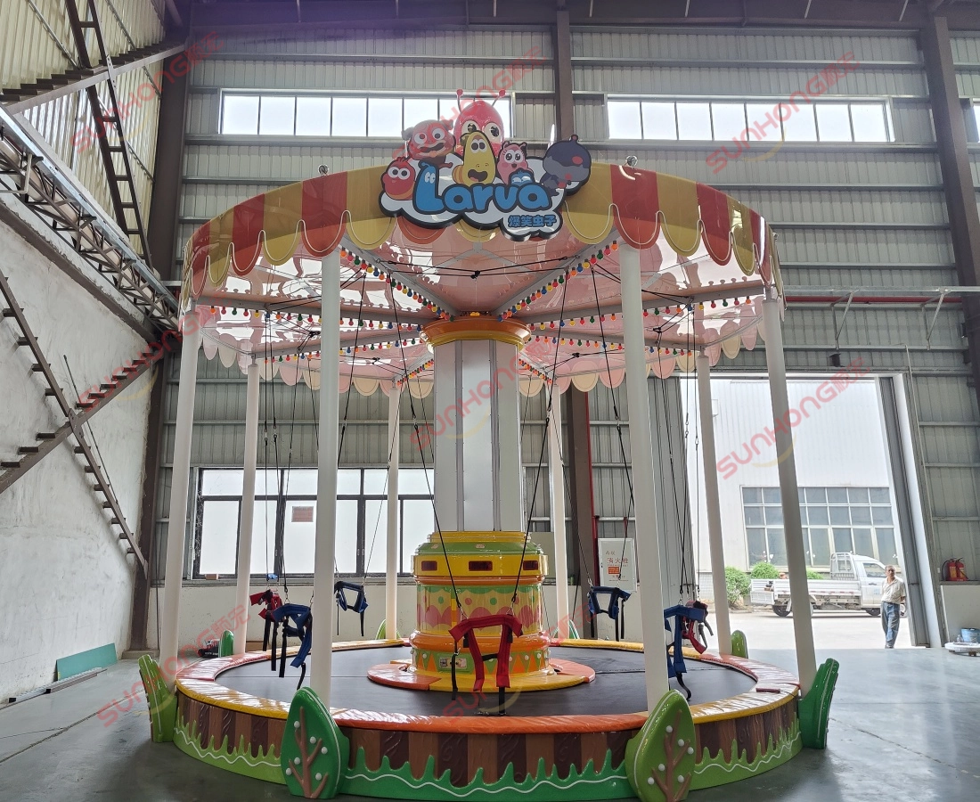 Side-view-photo-of-Larva-Bungee-Party-bungee-jumping-trampoline-taken-at-SUNHONG-factory. - SUNHONG Front view photo of the Larva Bungee Party trampoline ride at SUNHONG’s production workshop. - SUNHONG