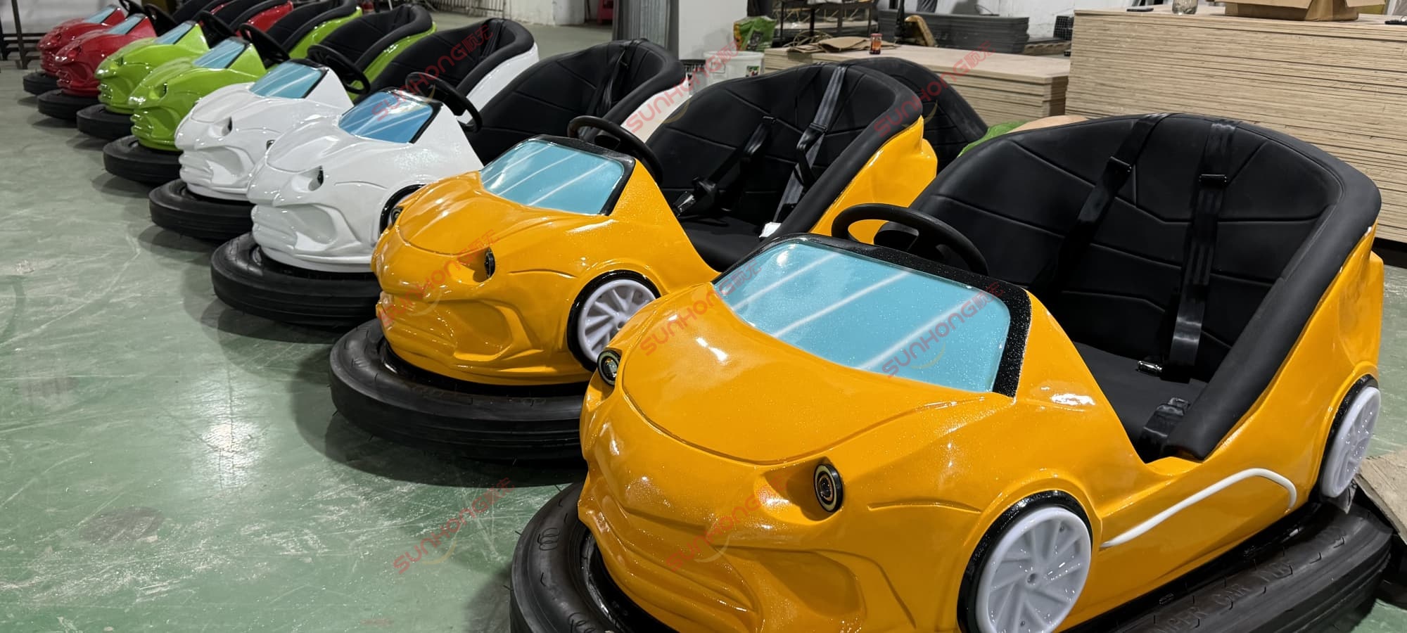 sports-style-bumper-cars-for-adults-for-sale Sports-style adult bumper cars in yellow, white, and green on showroom floor