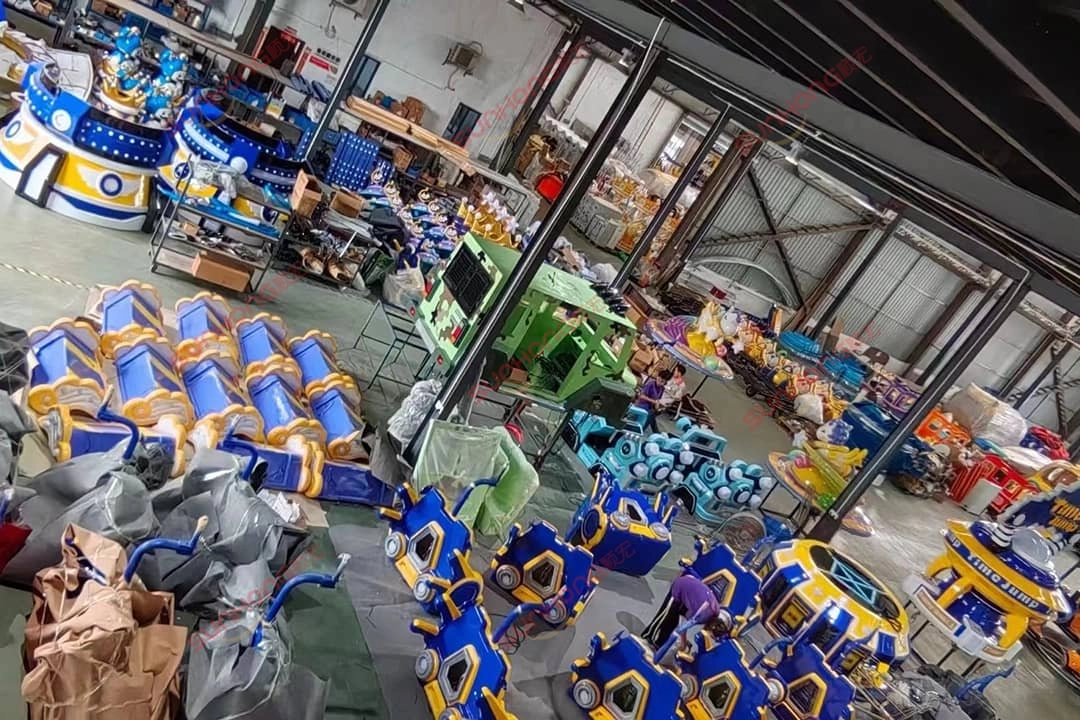 Trabalhadores da SUNHONG organizam componentes do brinquedo Time Jump na oficina da fábrica Trabalhadores da SUNHONG organizando componentes do Time Jump Ride na oficina da fábrica
