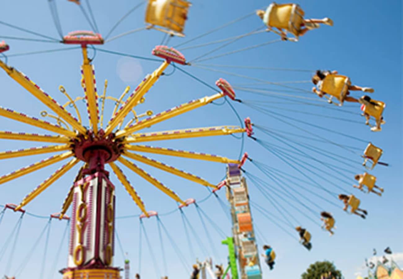 Swing ride operating at amusement park, showing proper function and importance of ride inspections