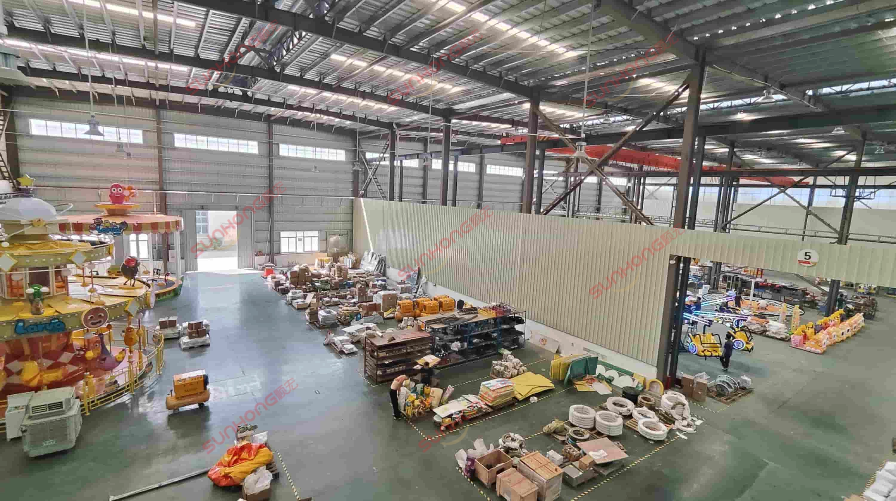 theme-park-ride-manufacturing-facility - SUNHONG Wide view of SUNHONG’s amusement equipment factory showing partially assembled rides and organized materials for production. - SUNHONG