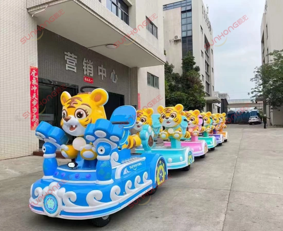 tigger-trackless-train-factory-showcase - SUNHONG Tigger trackless small train ride lineup showcased outdoors at the factory marketing center. - SUNHONG