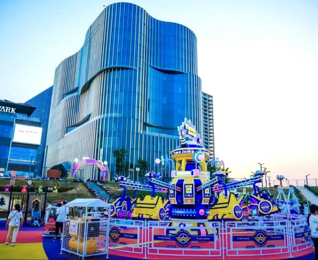 Time Jump ride in front of a commercial center with office towers in the background - SUNHONG