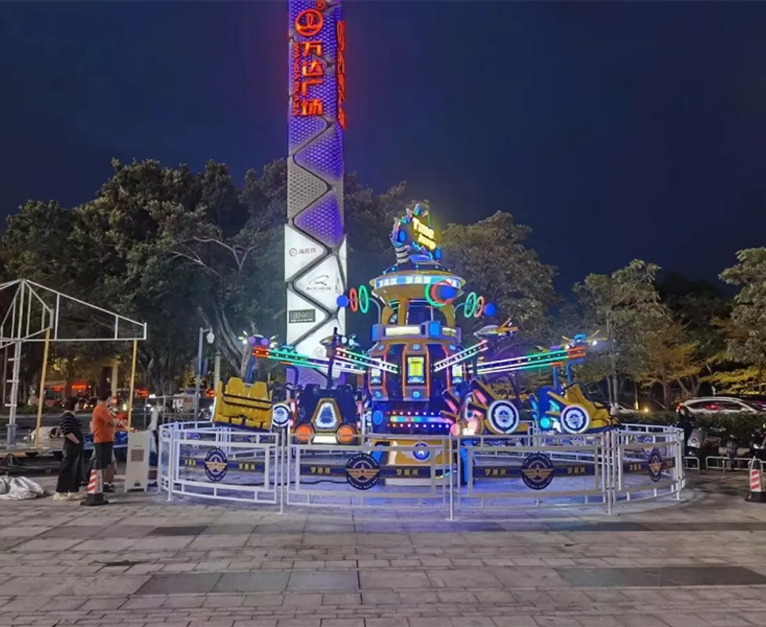 Time Jump ride at night in a commercial plaza with people waiting in line - SUNHONG