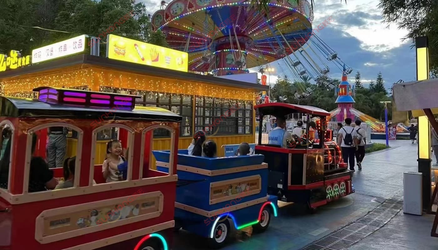 trackless-train-at-night Kingly Trackless Train operating in a theme park at night, lit up with LED lights – example of a completed trackless train build
