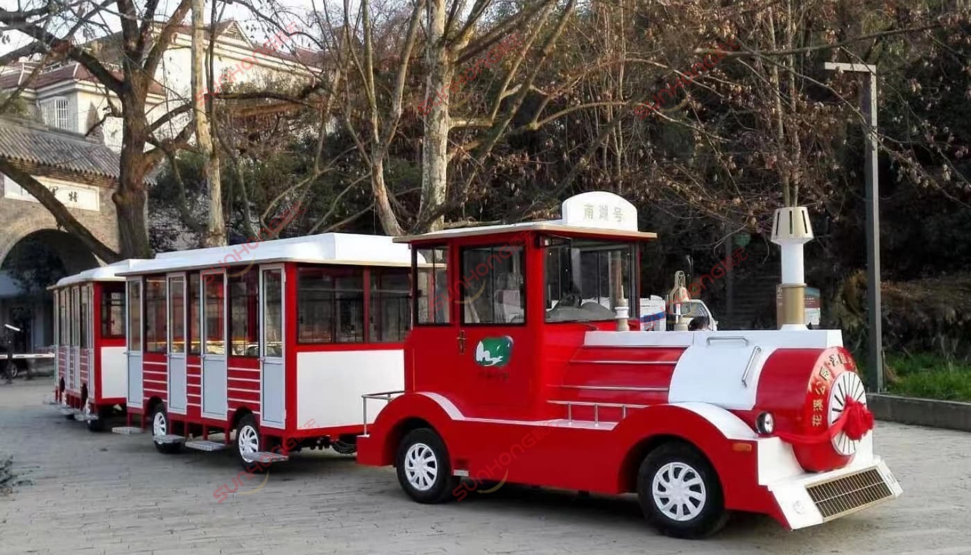 vintage-style-trackless-train Vintage-style red and white trackless train operating in a scenic tourist area – example of completed trackless train model