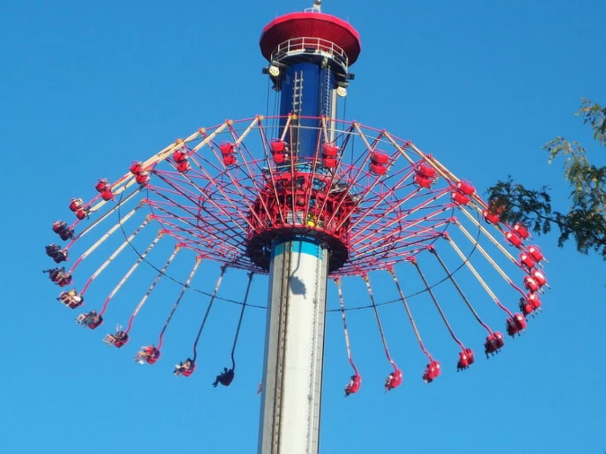 Amusement park ride: the tall tower swing, WindSeeker, in operation.