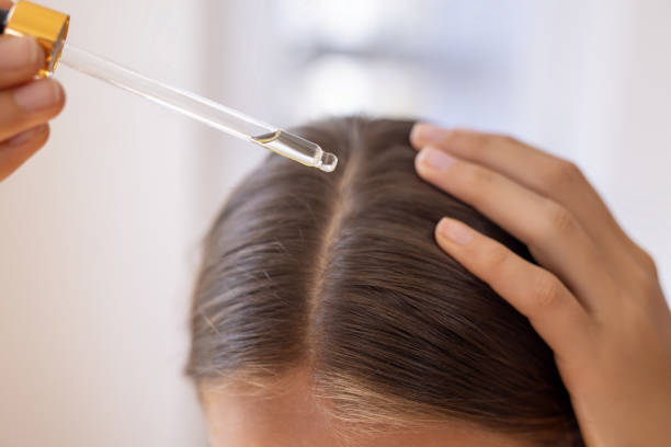 Hair repair damaged hair: Applying serum to scalp.