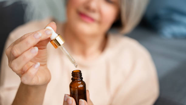 Woman applying private label hair growth oil. Woman applying private label hair growth oil.