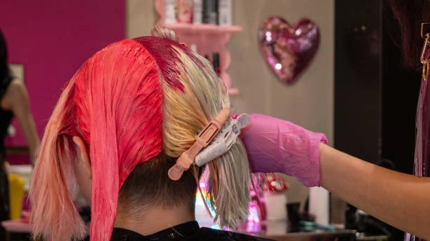 Beauty supply hair dye application on pink and blonde hair.