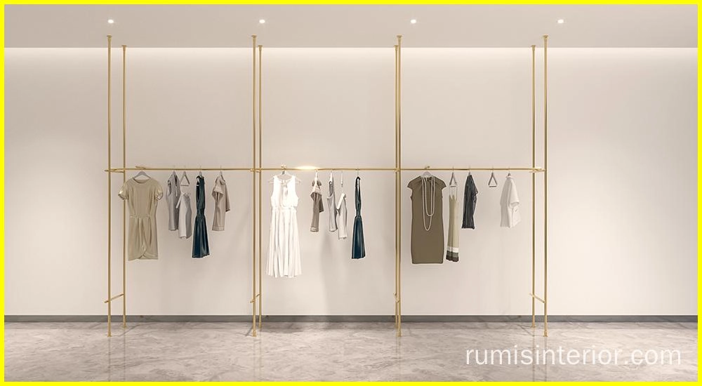 Elegant gold EOS shopfitting display systems showcasing apparel on a clean, minimalist backdrop. - RUMIS