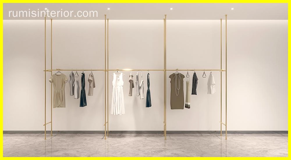 Elegant gold EOS shopfitting display systems showcasing apparel on a clean, minimalist backdrop. - RUMIS