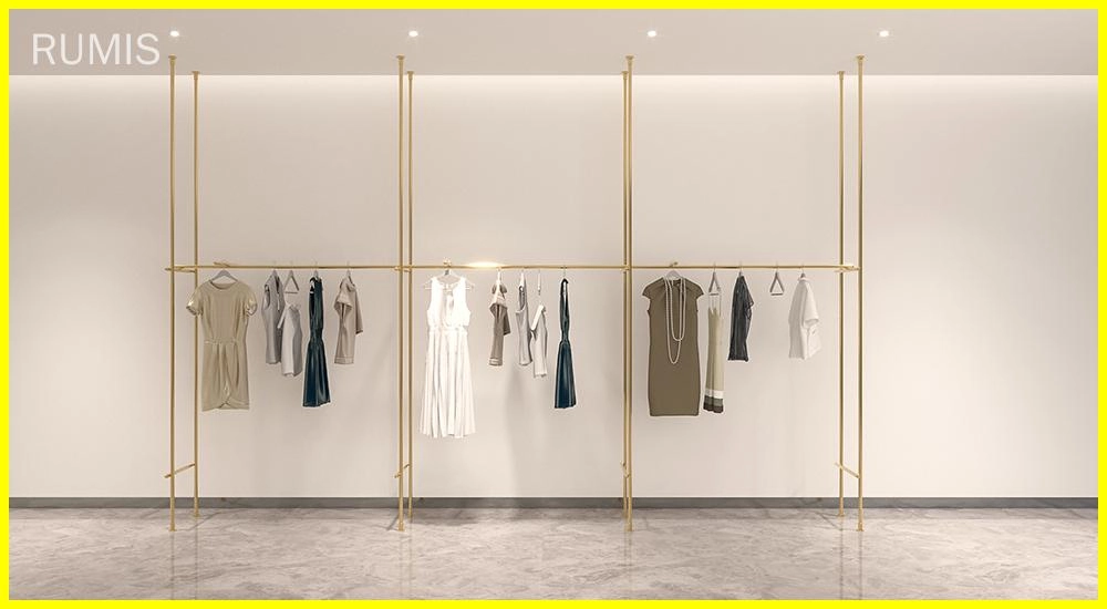 Elegant gold EOS shopfitting display systems showcasing apparel on a clean, minimalist backdrop. - RUMIS