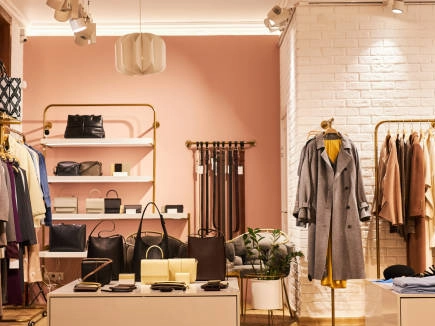 Stylish clothing display rack in a boutique showcasing apparel and accessories.