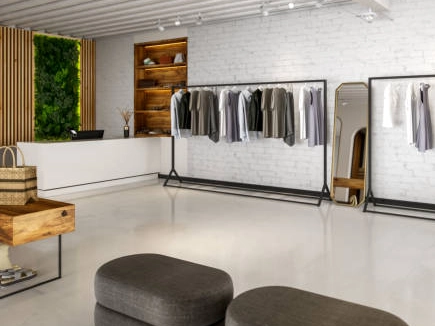 Modern boutique interior with metal clothing rack.