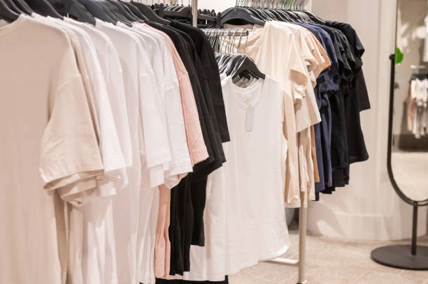 Commercial clothing rack with neutral-toned shirts.