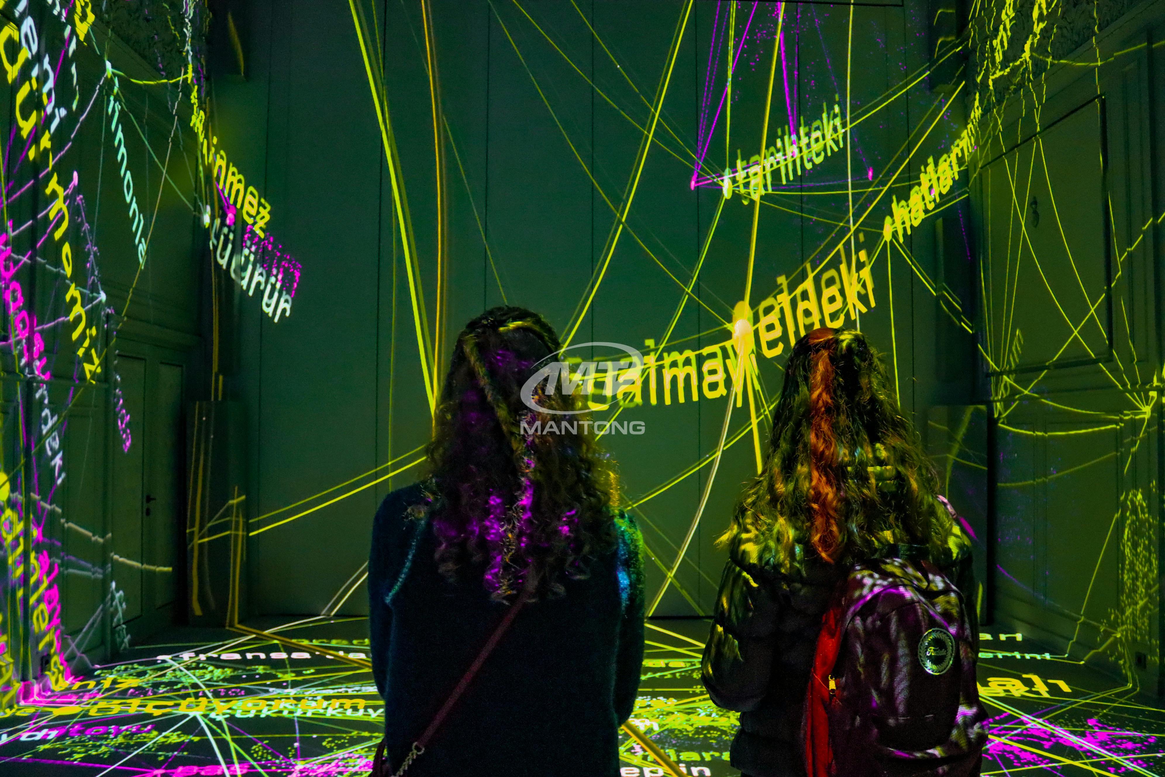 Interactive Projection Mapping People view Interactive Projection Mapping art with colorful lights and words.