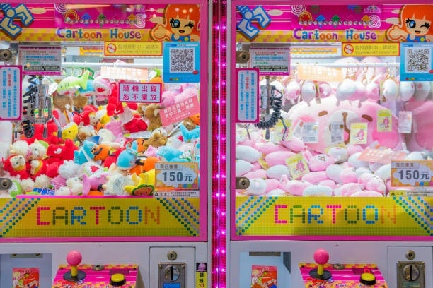 Pink toy grabber claw machine filled with plush toys.