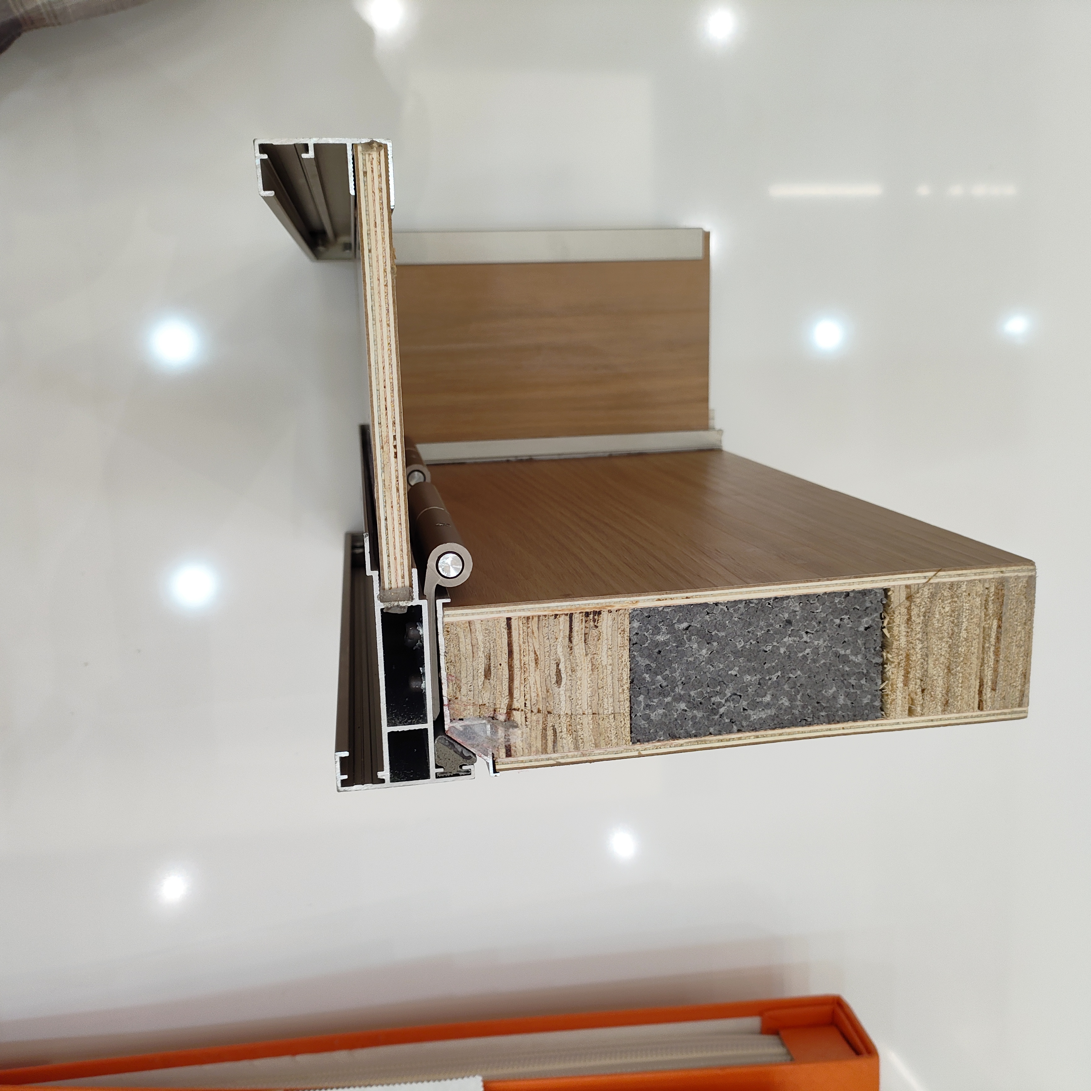 Modern bir kapının iç yapısını ve alüminyum çerçevesini gösteren kesit. Modern bir kapının iç yapısını ve alüminyum çerçevesini gösteren kesit.